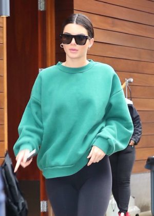 Kendall Jenner - Wearing black leggings and a green sweatshirt in NYC