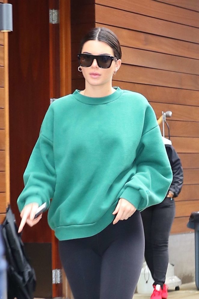 Kendall Jenner - Wearing black leggings and a green sweatshirt in NYC