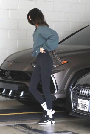 Kendall Jenner - Wearing black yoga pants and an oversized top in West Hollywood