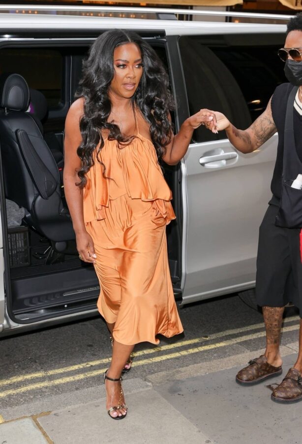 Kenya Moore - Wearing a bright orange dress at Bauer Media offices in London