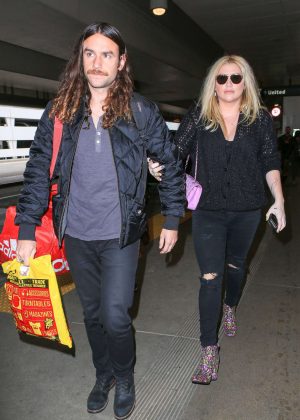 Kesha with boyfriend Brad Ashenfelter at LAX Airport in Los Angeles