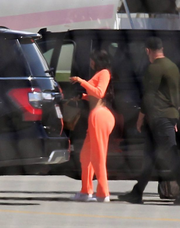 Kylie Jenner - In orange jumpsuit Touches down in Palm Springs