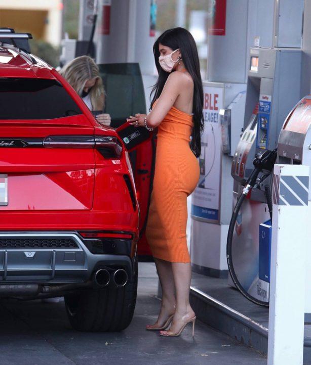 Kylie Jenner - Pumps gas into her new red Lamborghini SUV in Bel Air