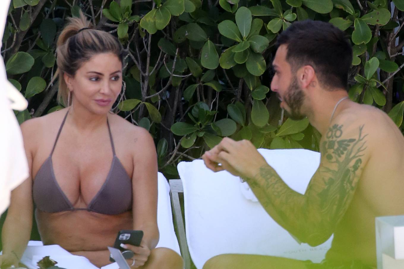 Larsa Pippen - In a bikini with a mystery man by the pool in Miami. 