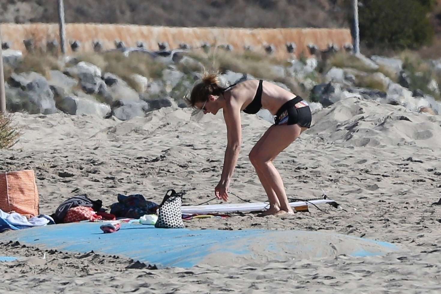 Laura Dern in Shorts and a Bikini Top at a beach in Malibu. 