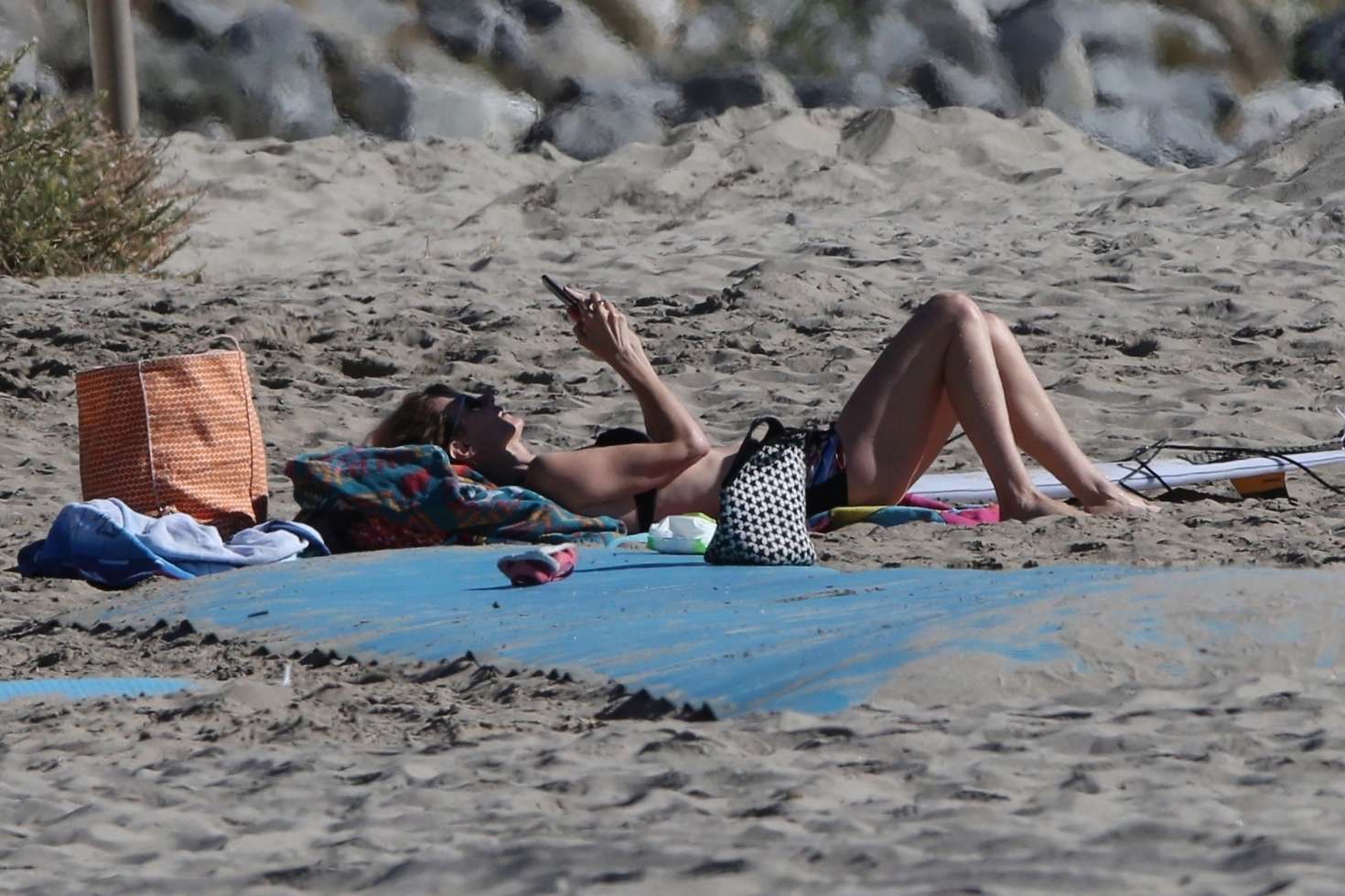 Laura Dern in Shorts and a Bikini Top at a beach in Malibu. 