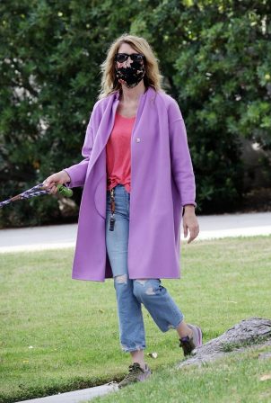 Laura Dern - Walking her dog dressed in a nice purple jacket in Pacific Palisades