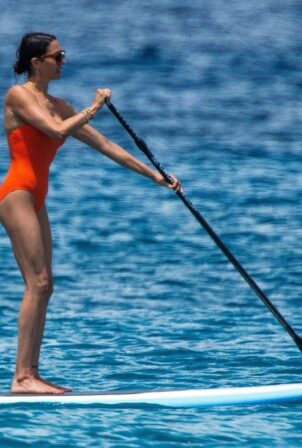 Lauren Silverman - In orange swimwear riding the waves in St. James - Barbados