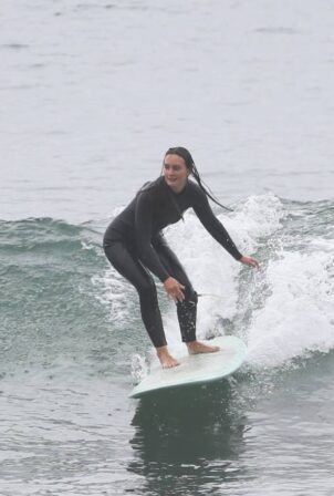 Leighton Meester - gets on her surfboard in Santa Monica