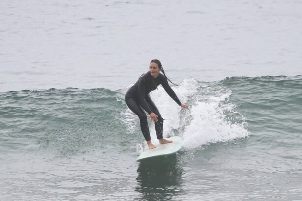 Leighton Meester - gets on her surfboard in Santa Monica