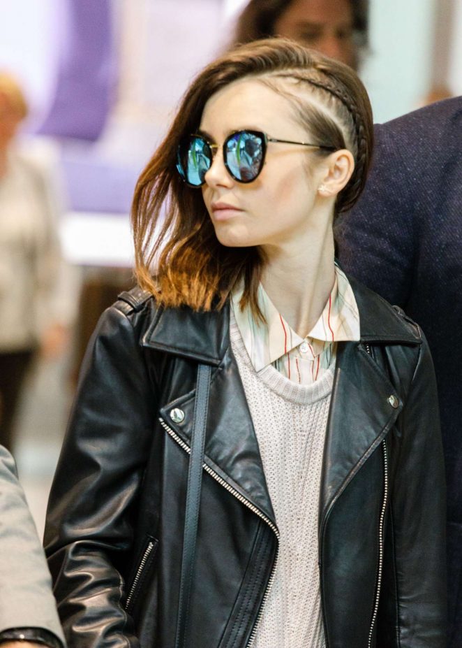 Lily Collins Arrives at Heathrow Airport in London