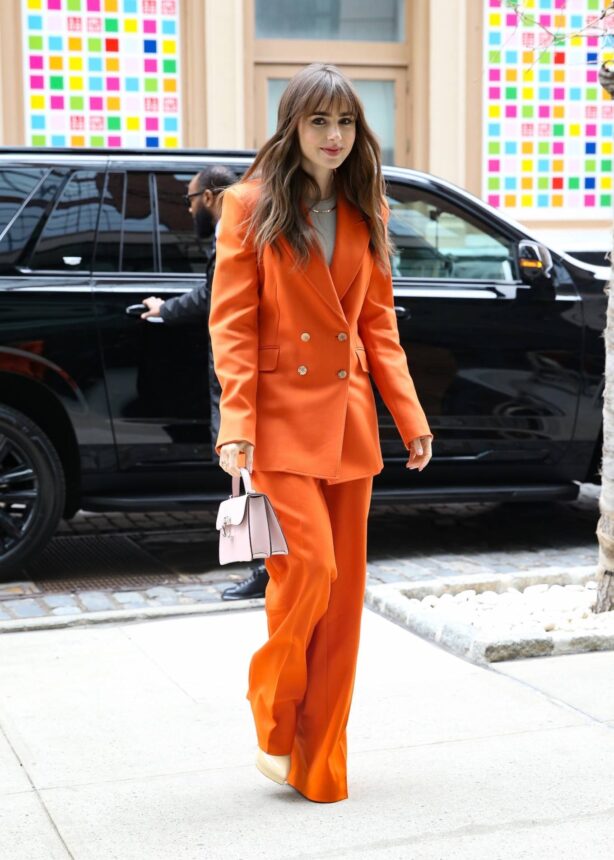 Lily Collins - Arrives at the Crosby Hotel in a fashionable red pantsuit in New York