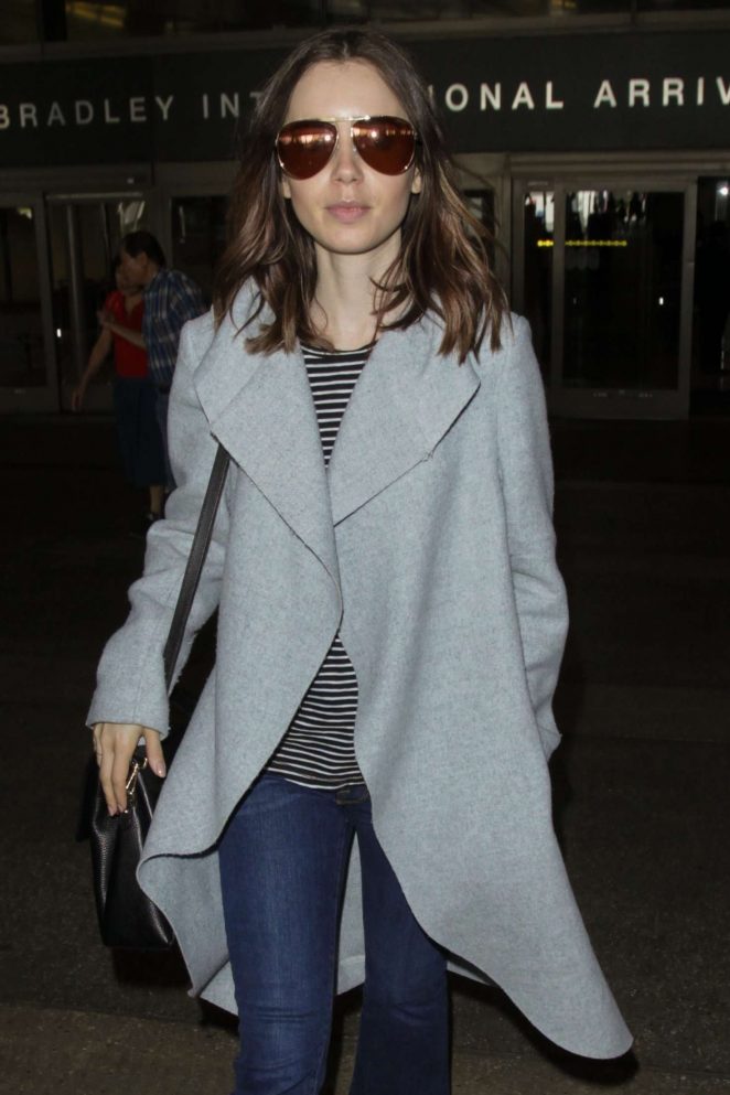 Lily Collins - Arriving at Los Angeles International Airport