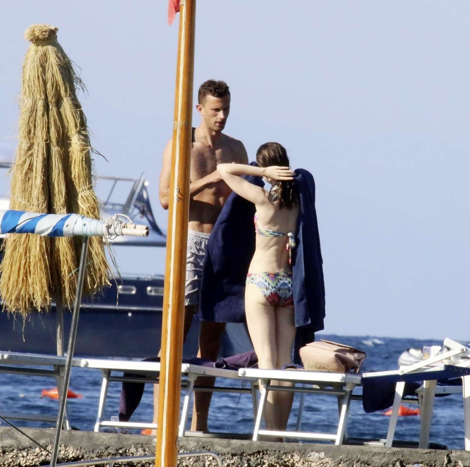 Lily Collins in a bikini on the beach in Ischia. 