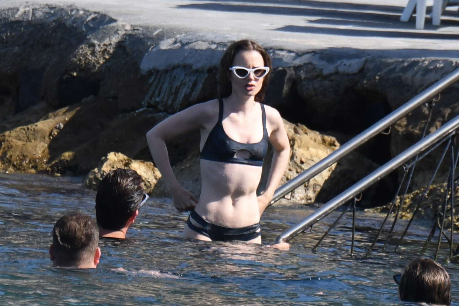 Lily Collins in Black Bikini at the beach in Ischia. 