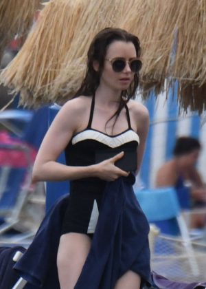Lily Collins in Black Swimsuit at the Isabella hotel in Ischia