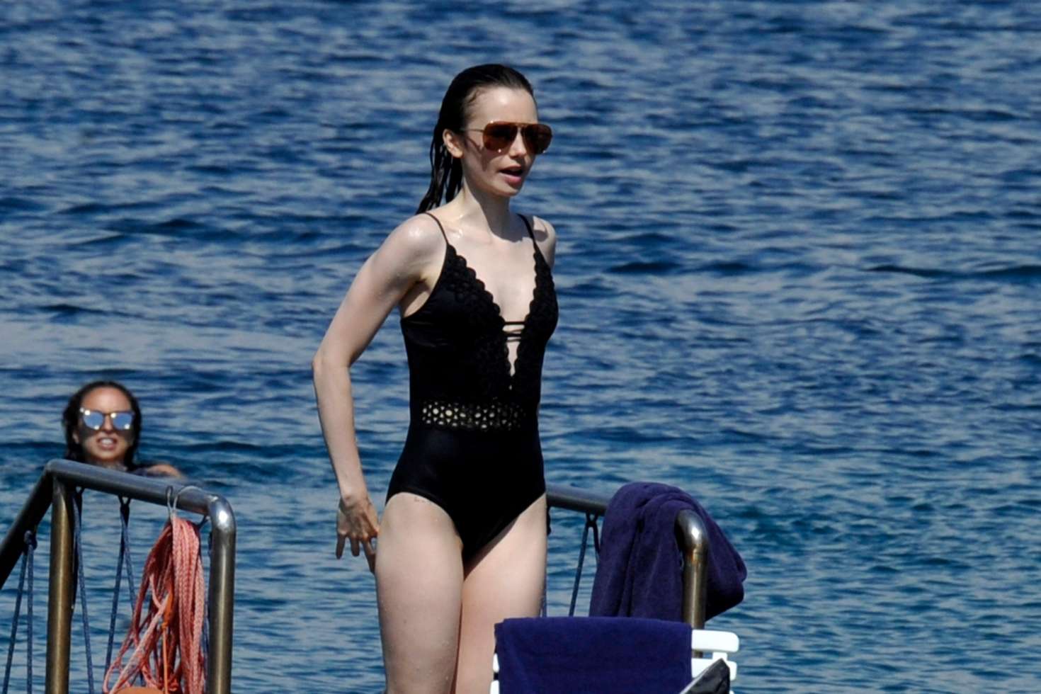 Lily Collins in Swimsuit at the beach in Italy. 