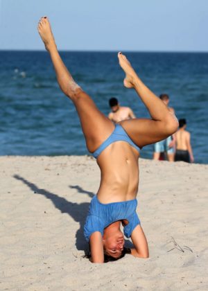 Lucy Aragon in Bikini does yoga on the beach in Miami