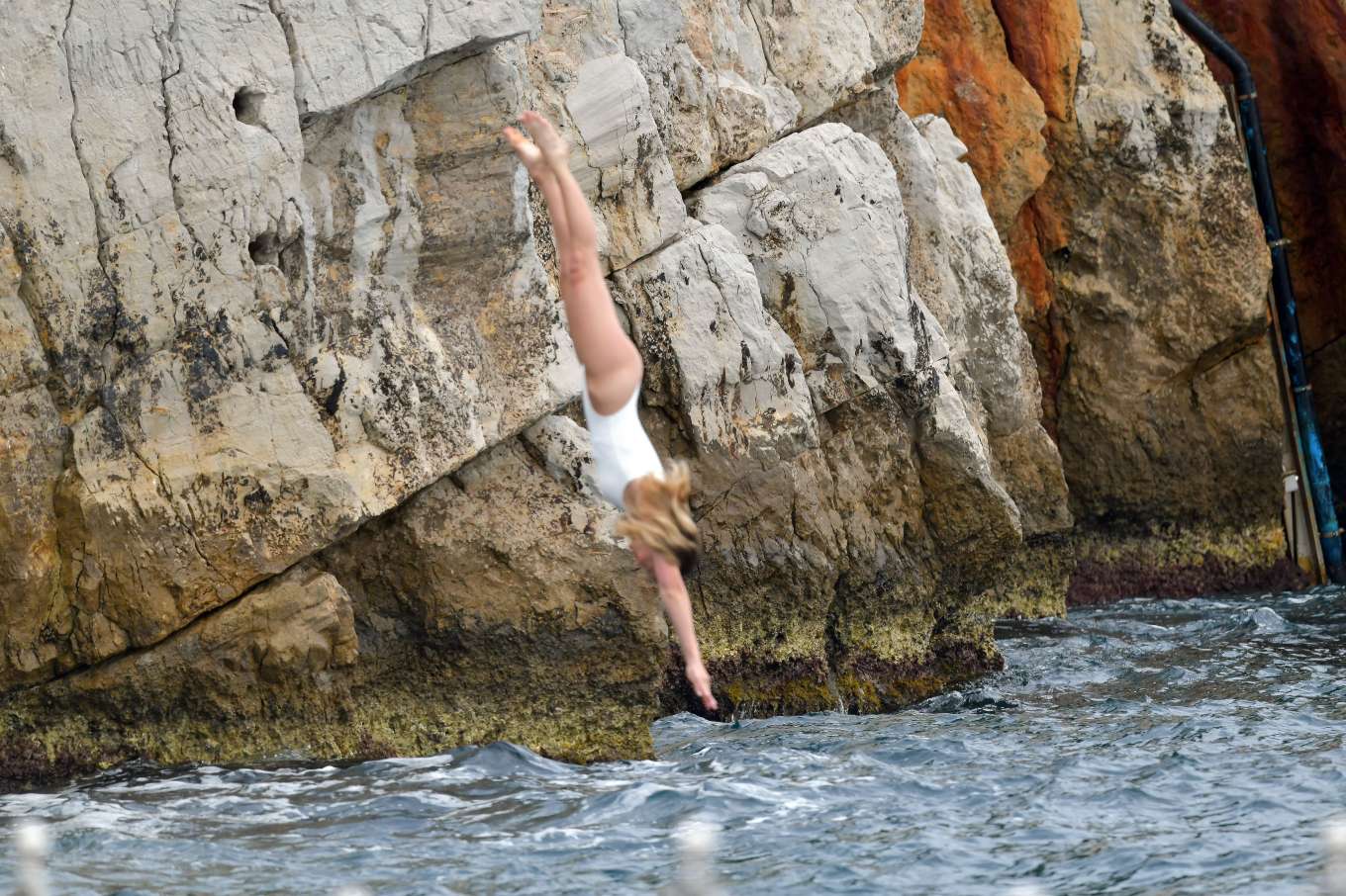 Margot Robbie in White Swimsuit at Eden Roc hotel in Cannes. 