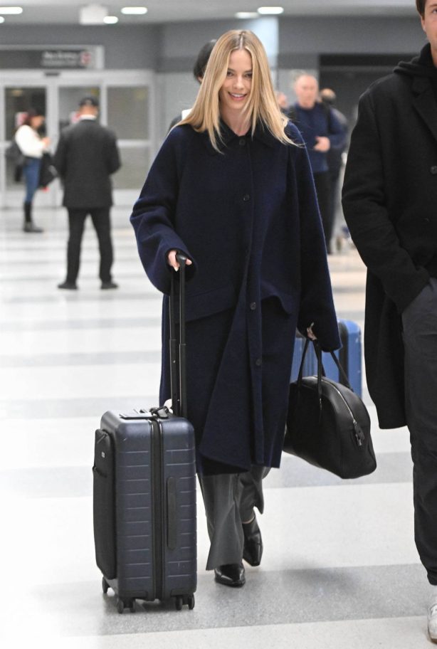 Margot Robbie - With her husband Tom Ackerley arriving on a flight at JFK Airport in NY