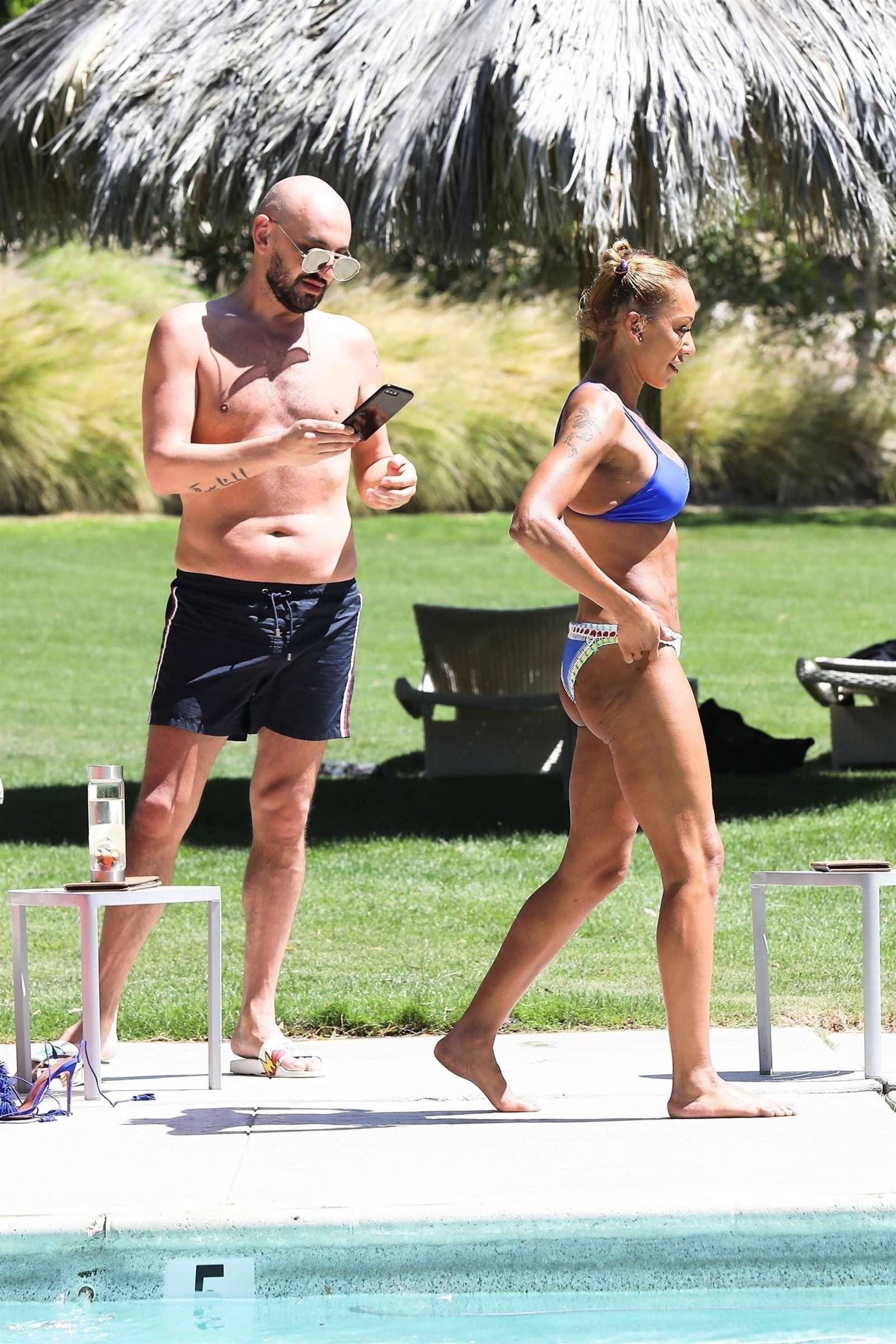 Melanie Brown in Blue Bikini on the pool in Palm Springs. 