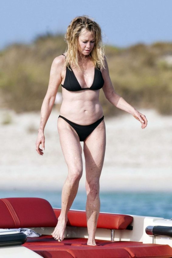 Melanie Griffith in Black Bikini on a luxury yacht in Formentera