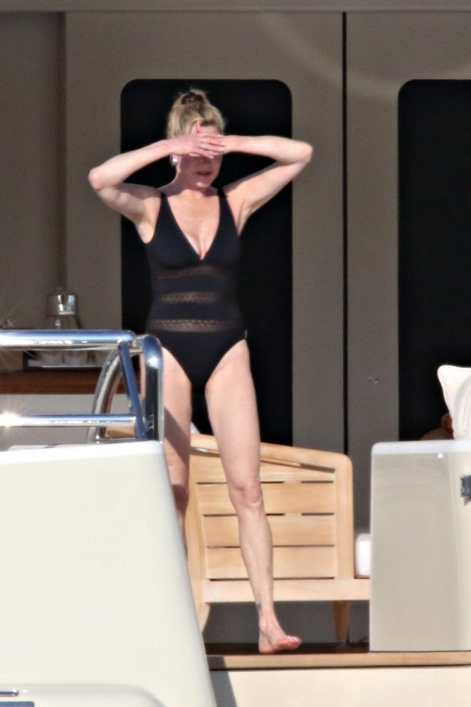 Melanie Griffith in Black Swimsuit on a boat in Sardinia