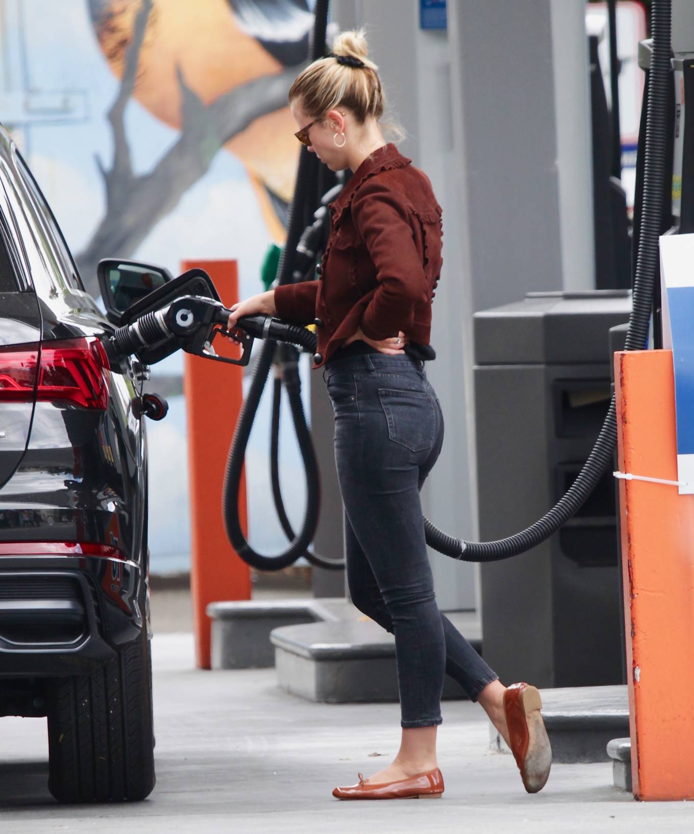 Mia Goth in Black Jeans at a gas station in Los Angeles