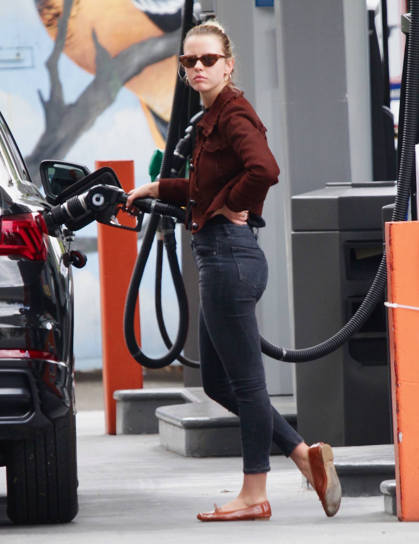 Mia Goth in Black Jeans at a gas station in Los Angeles
