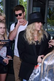 Miley Cyrus and Liam Hemsworth - Arrives at the airport in Warsaw