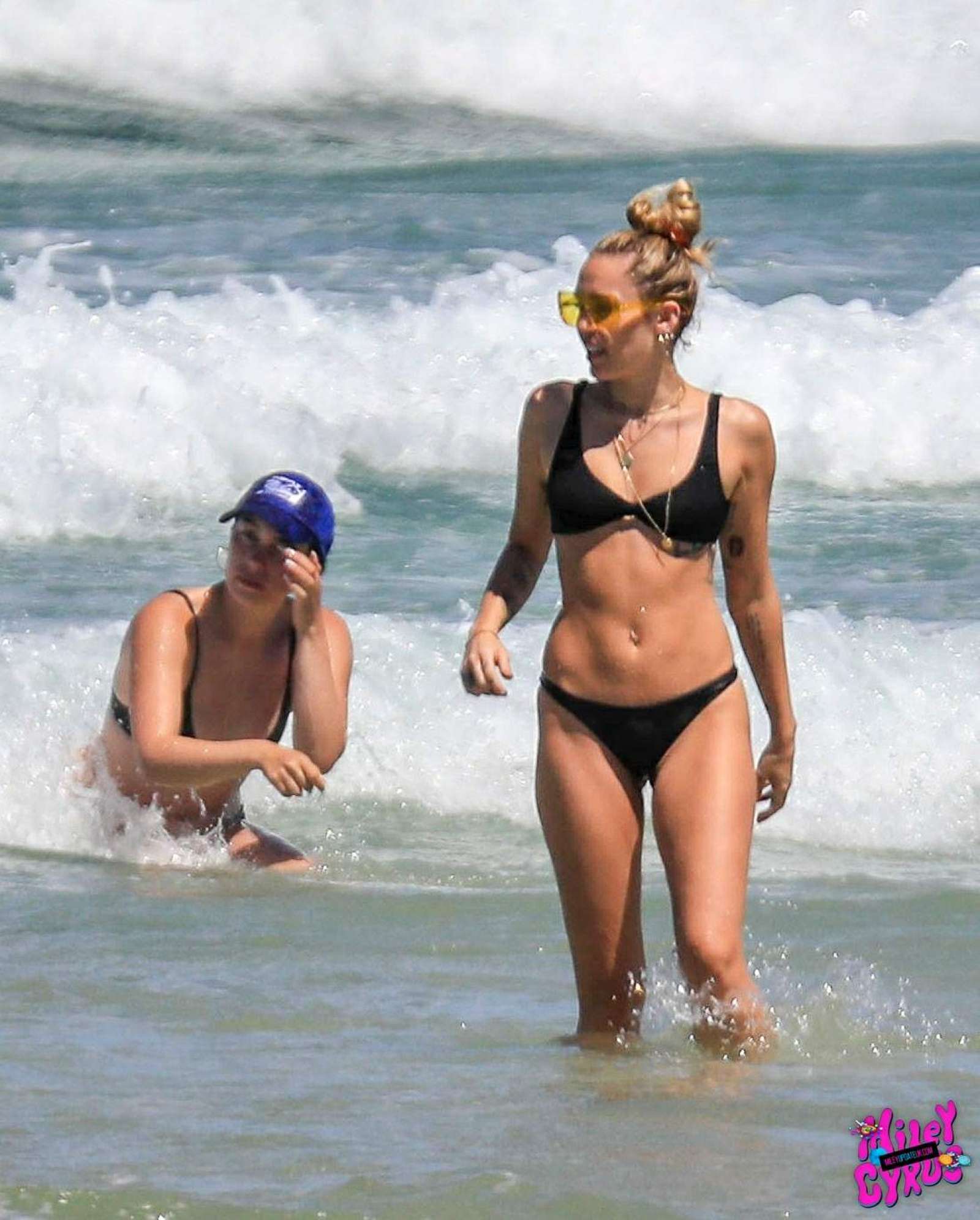 Miley Cyrus in Black Bikini at the beach in Byron Bay. 