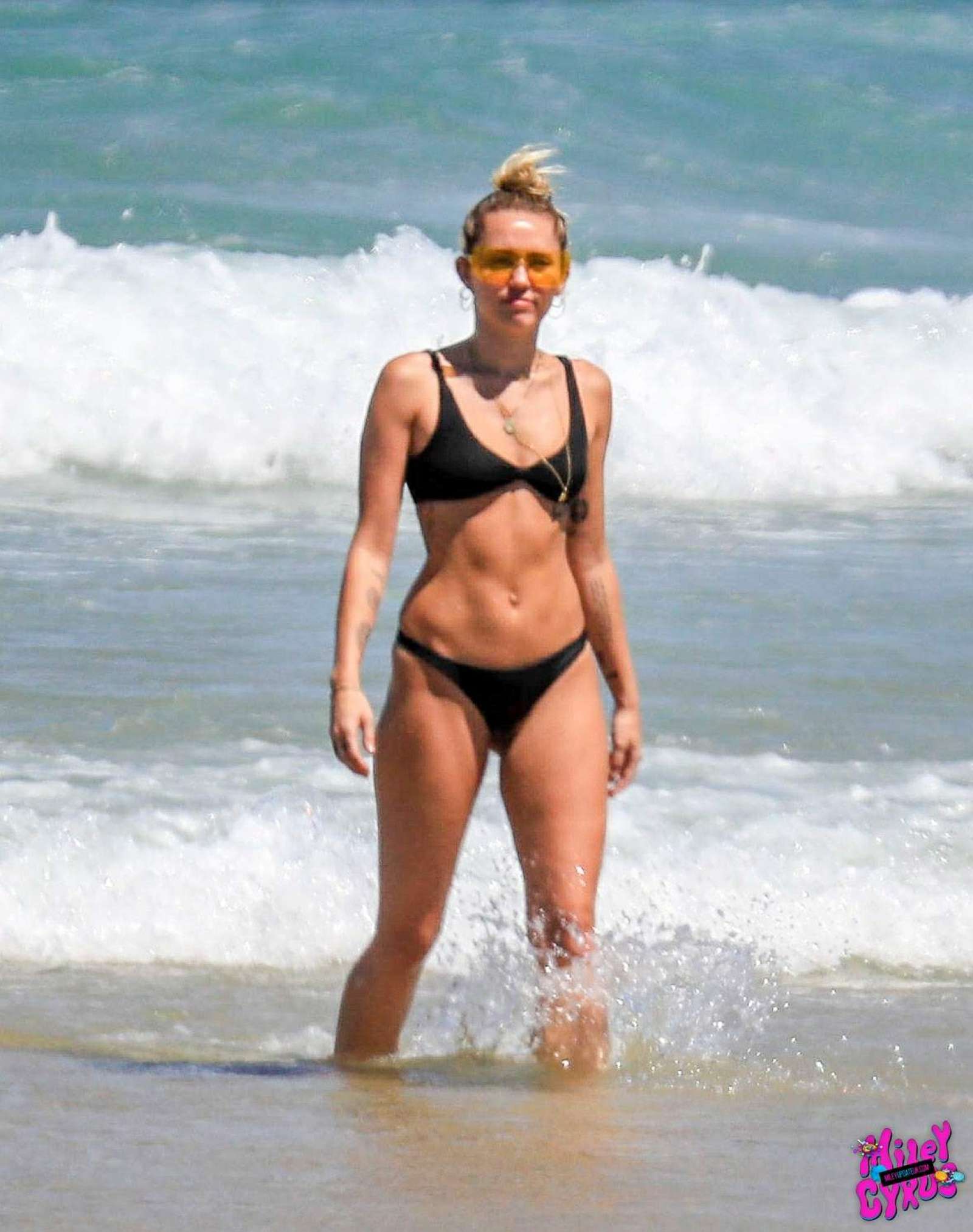 Miley Cyrus in Black Bikini at the beach in Byron Bay. 