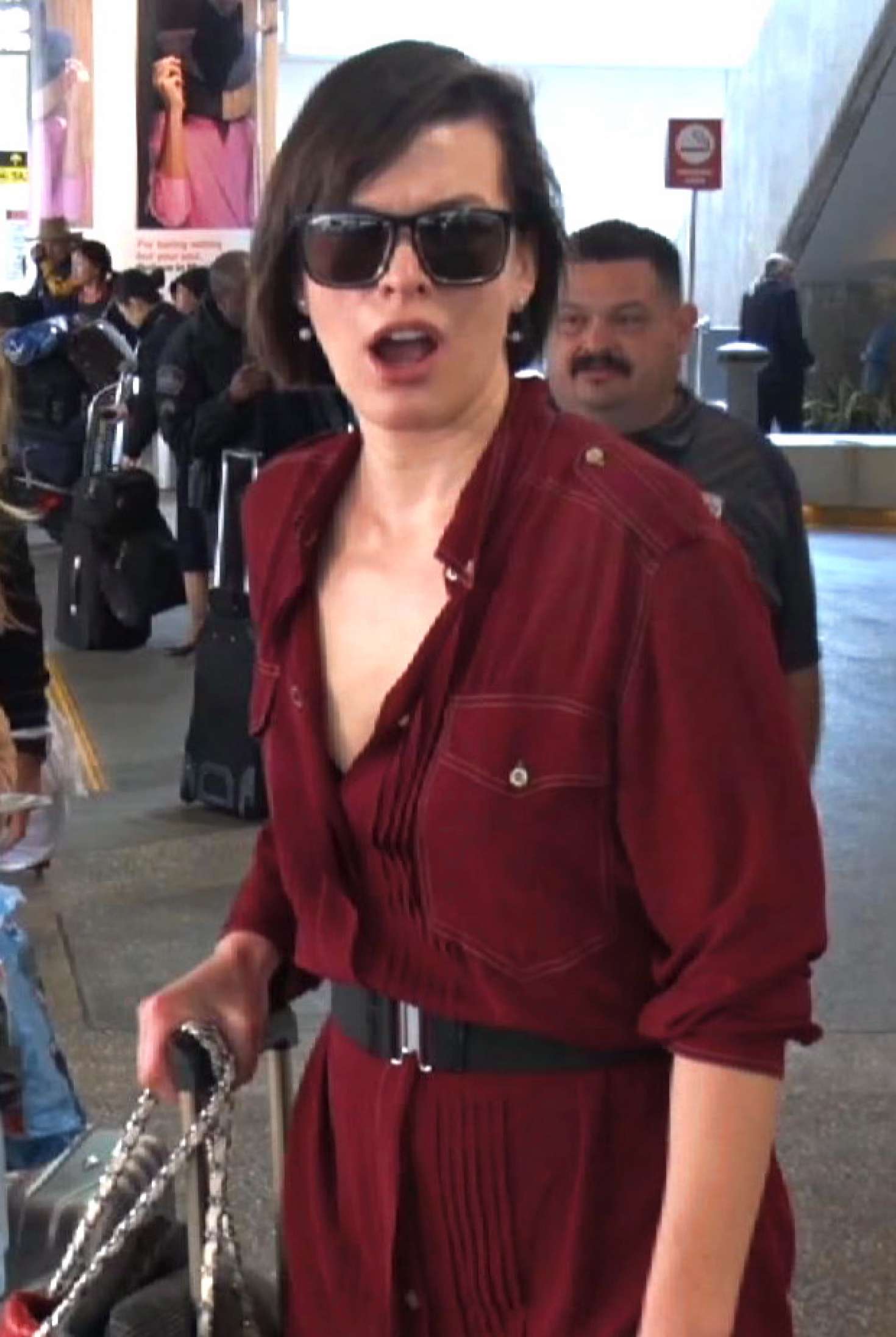 Milla Jovovich in Red Dress at LAX Airport in LA