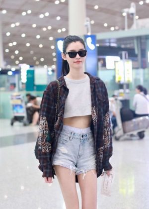 Ming Xi in Jeans Shorts at the Beijing Airport in China