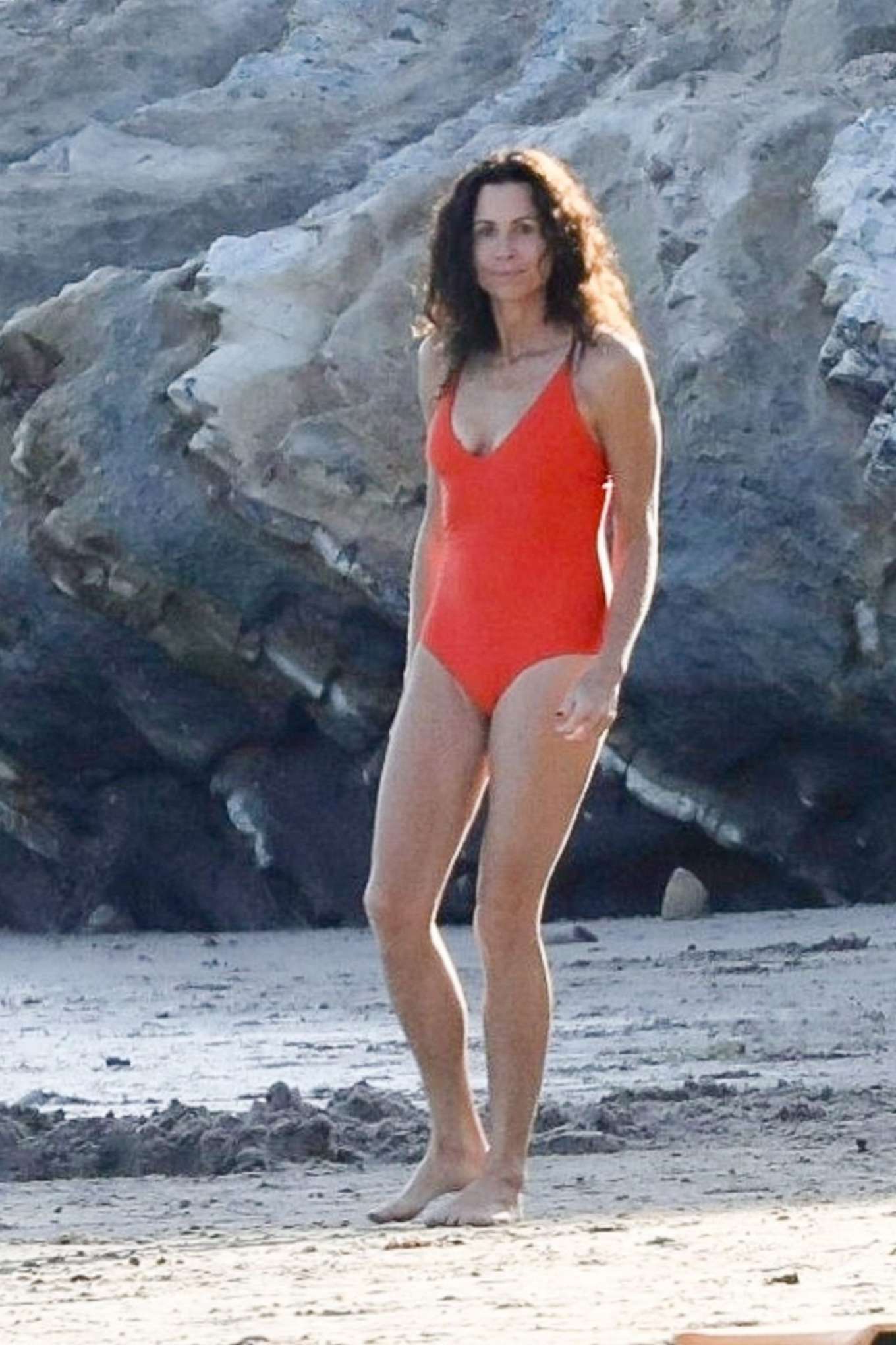 Minnie Driver in Orange Swimsuit on the beach in Malibu. 