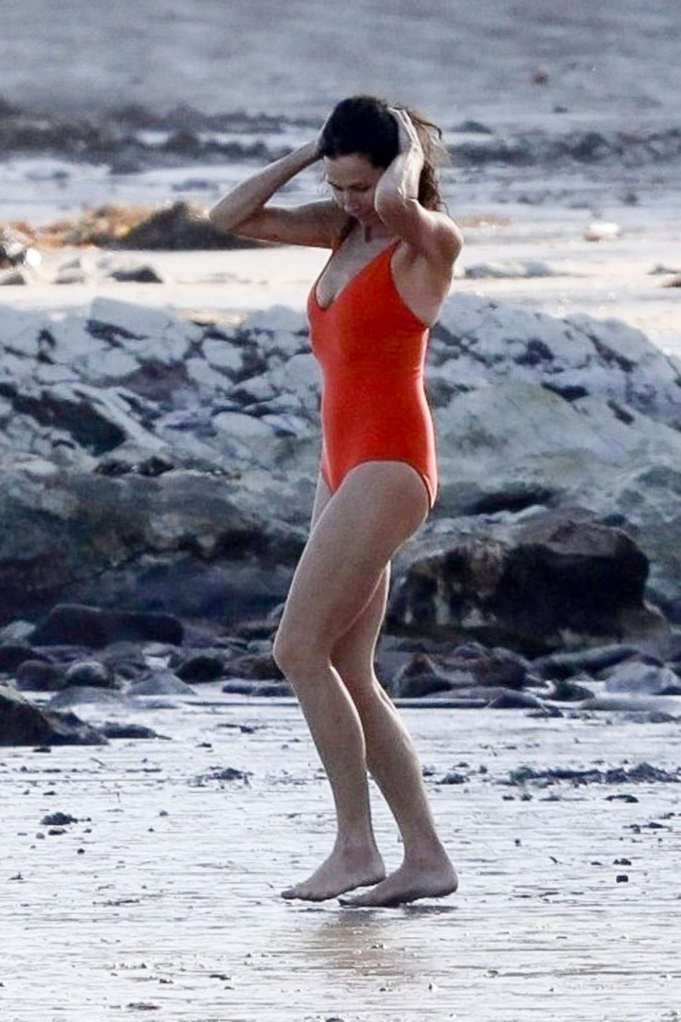 Minnie Driver in Orange Swimsuit on the beach in Malibu. 