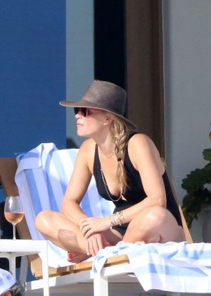 Molly Sims in Black Swimsuit on the pool in Cabo San Lucas