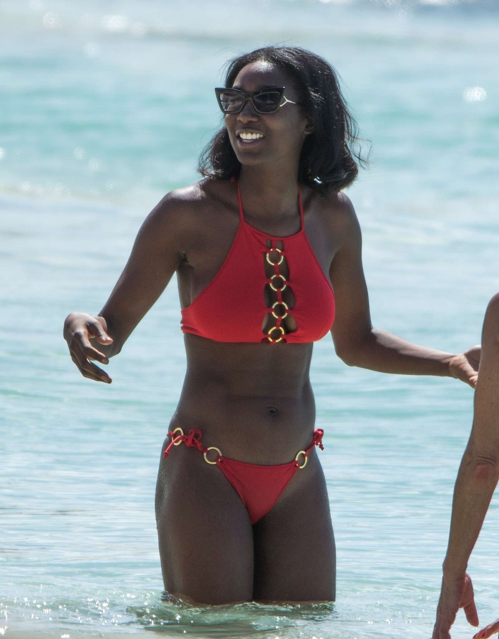 Mouna Traore in Red Bikini on the beach in Barbados. 