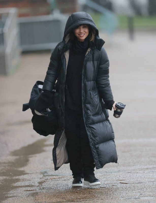 Myleene Klass - In black braves the rain gears in London
