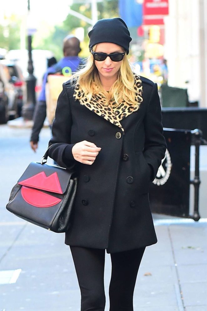 Nicky Hilton in a black coat with a leopard print collar out in New York City