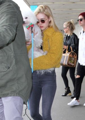 Nicola Peltz in Furry Yellow Jacket at LAX Airport in Los Angeles