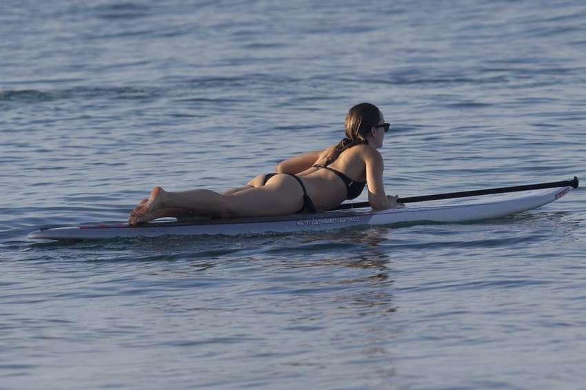 Olivia Wilde in Black Bikini Paddleboarding in Maui adds. 