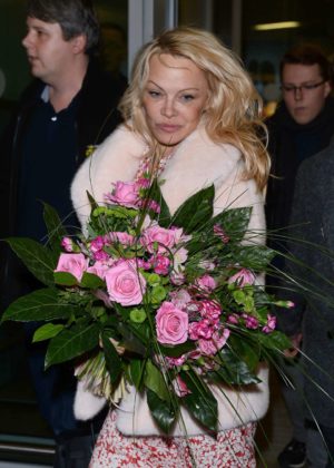 Pamela Anderson at the airport in Warsaw