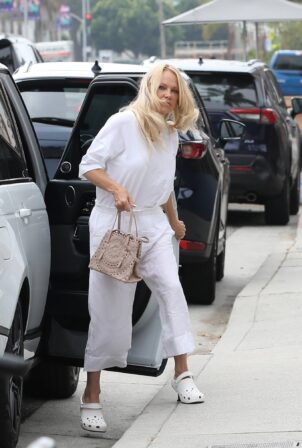 Pamela Anderson - Wears Crocs x Balenciaga mules while out in Venice.
