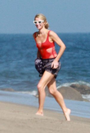 Paris Hilton - Wears a red swimsuit on the beach in Malibu