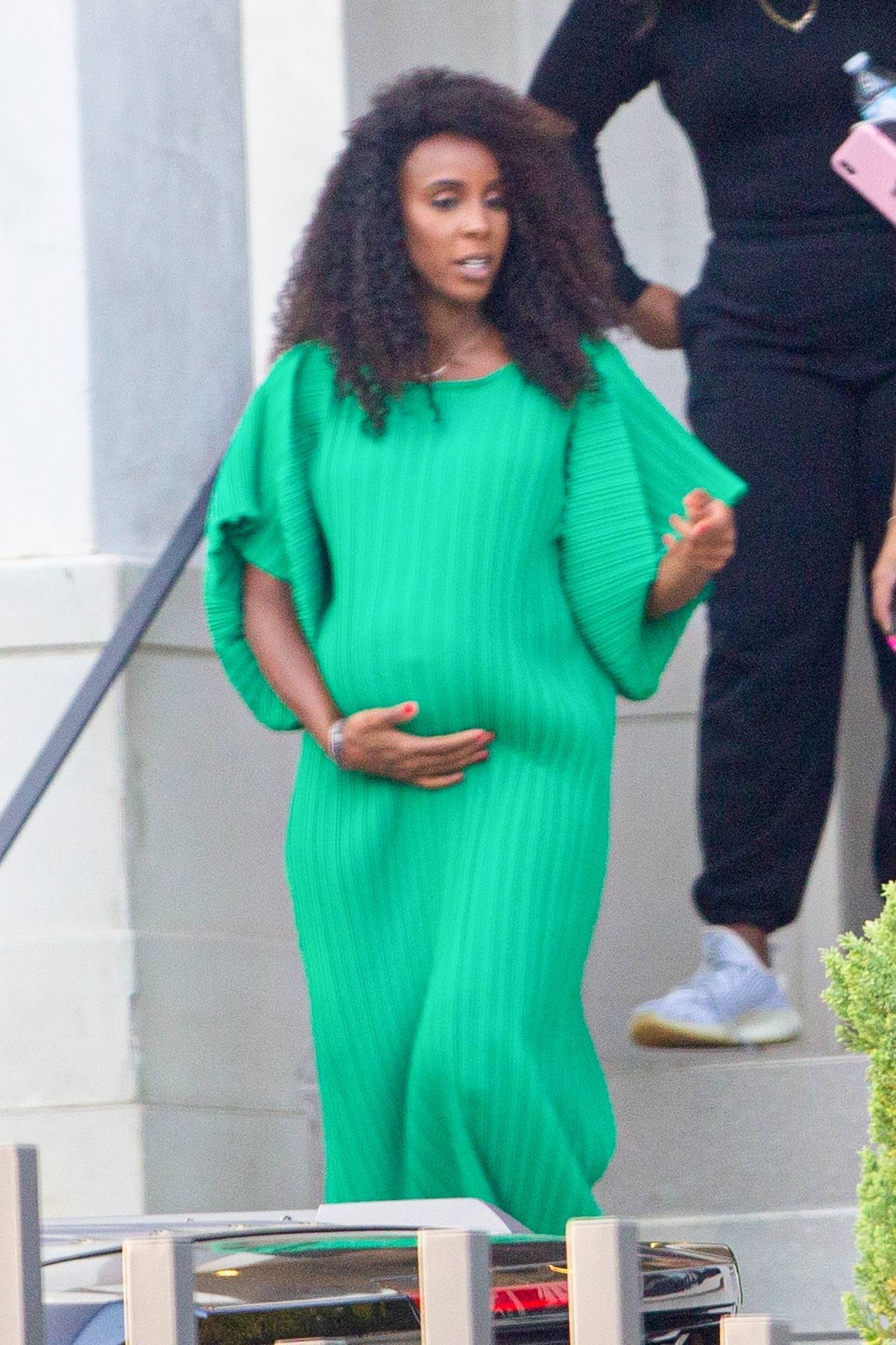 Pregnant Kelly Rowland – iI a green dress leaving a photo shoot in Brentwood