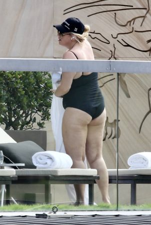 Rebel Wilson - Seen by the pool in a black swimsuit in Sydney