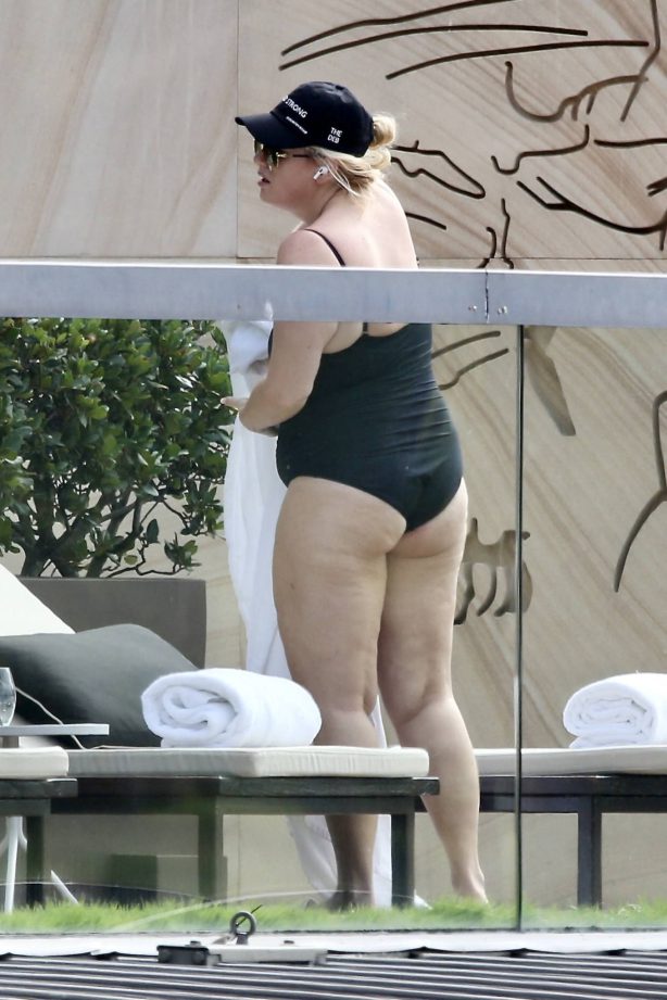 Rebel Wilson - Seen by the pool in a black swimsuit in Sydney