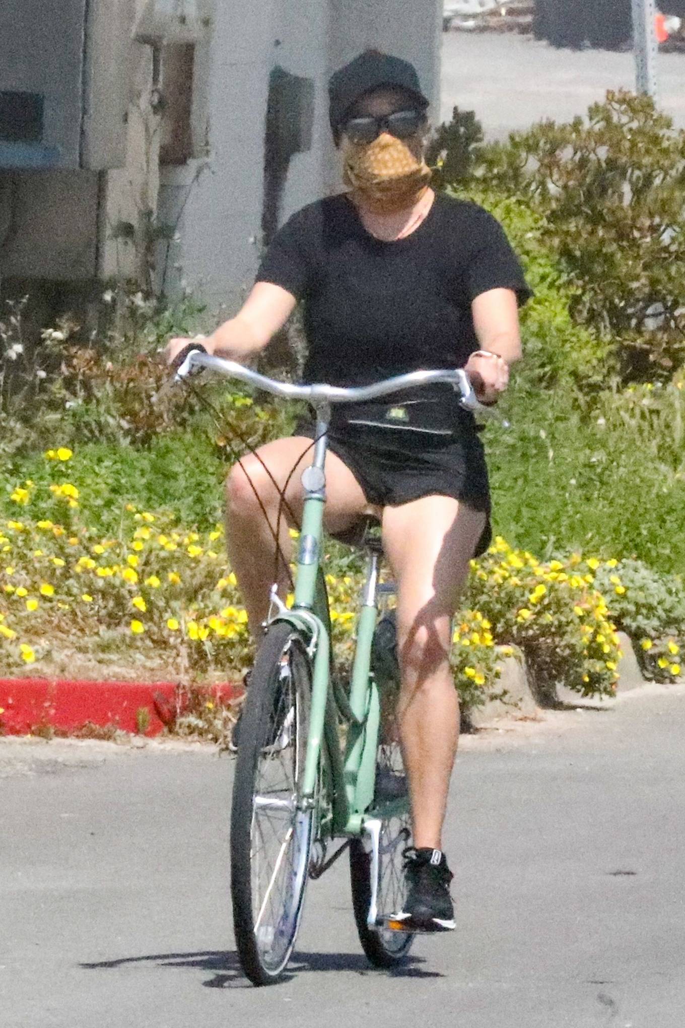 Reese Witherspoon â€“ Riding A Bicycle While Her Husband Jog