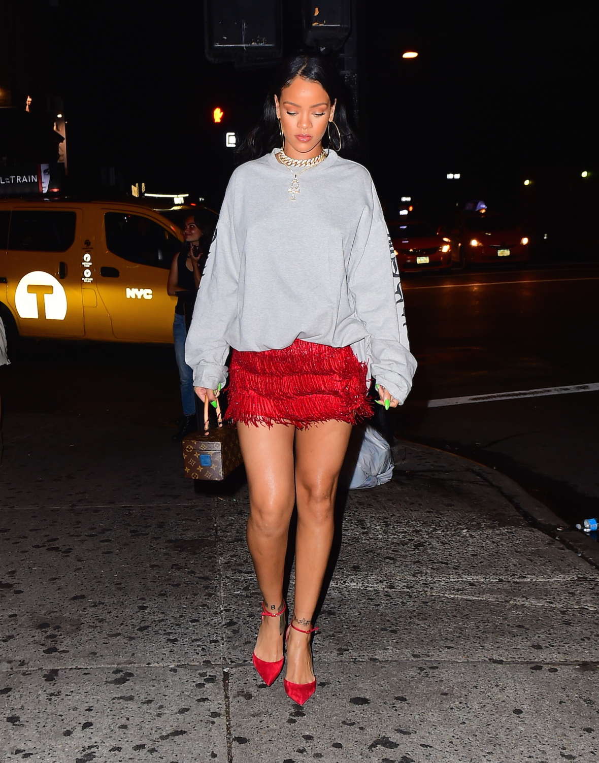 Rihanna in a red fringed skirt at Avenue Nightclub in NY